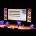 Lecture theatre with a podium and projector screen decorated with large jigsaw pieces