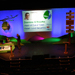 Lecture hall decorated as a field with spotlighting, on−stage seating and two podiums